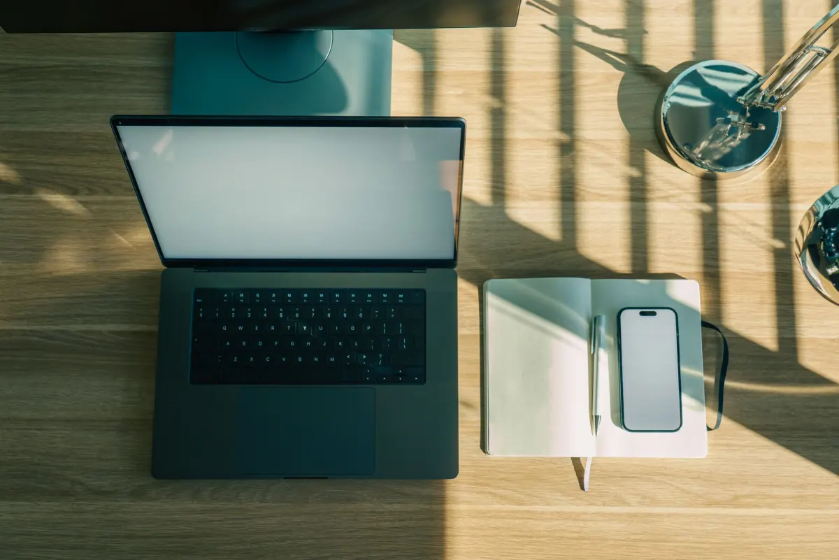Minimalist workspace with laptop and notebook